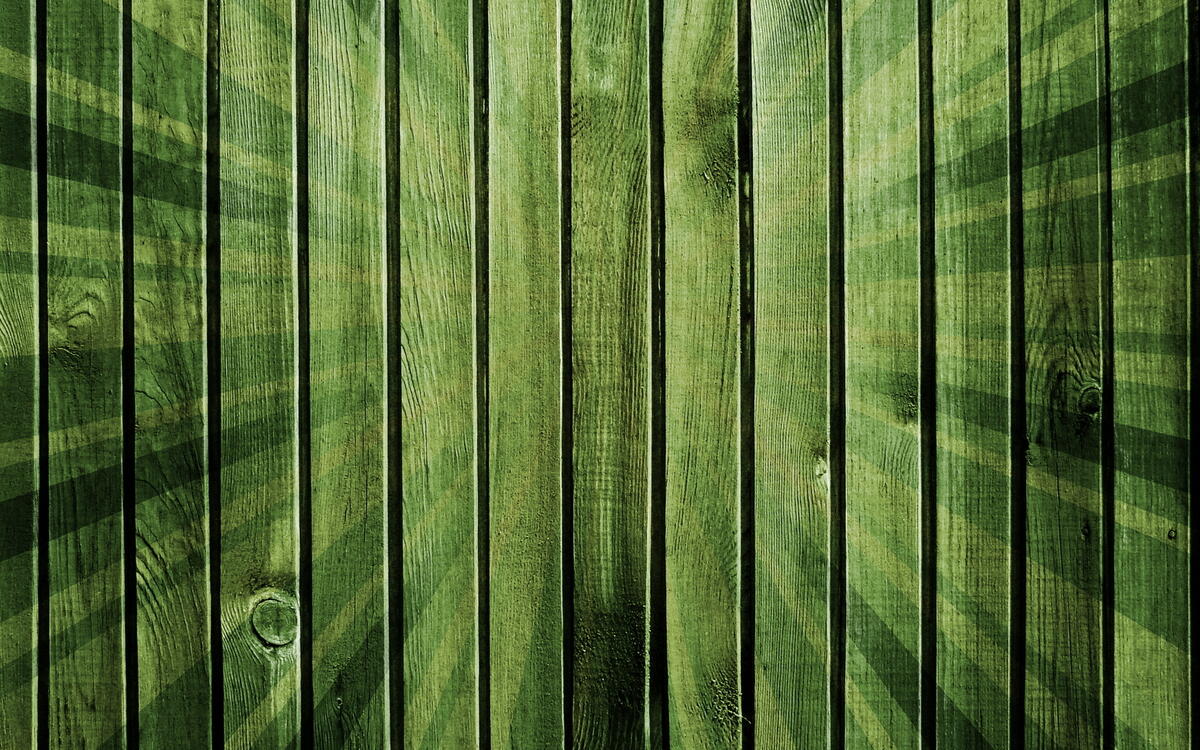 Green fence made of wooden planks