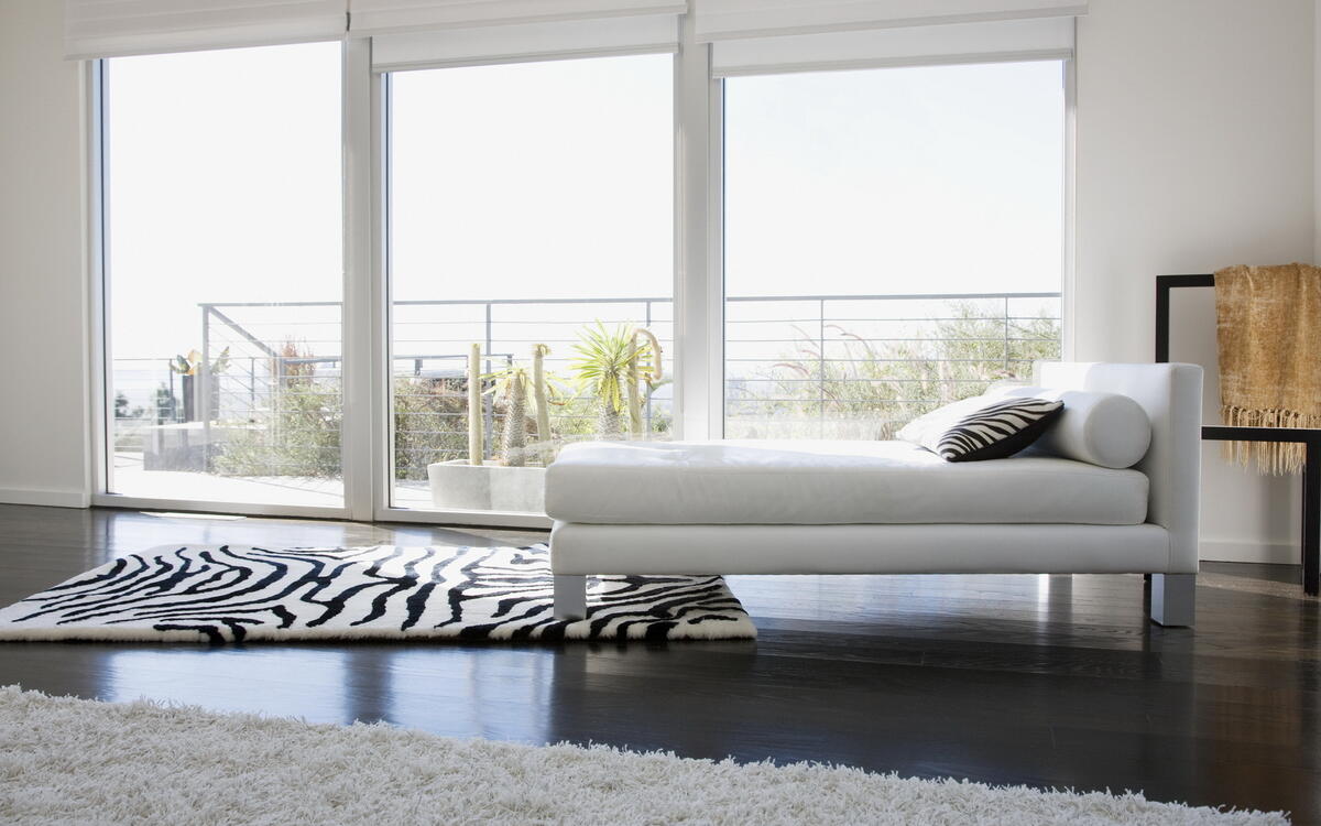 A zebra-colored rug under the couch.