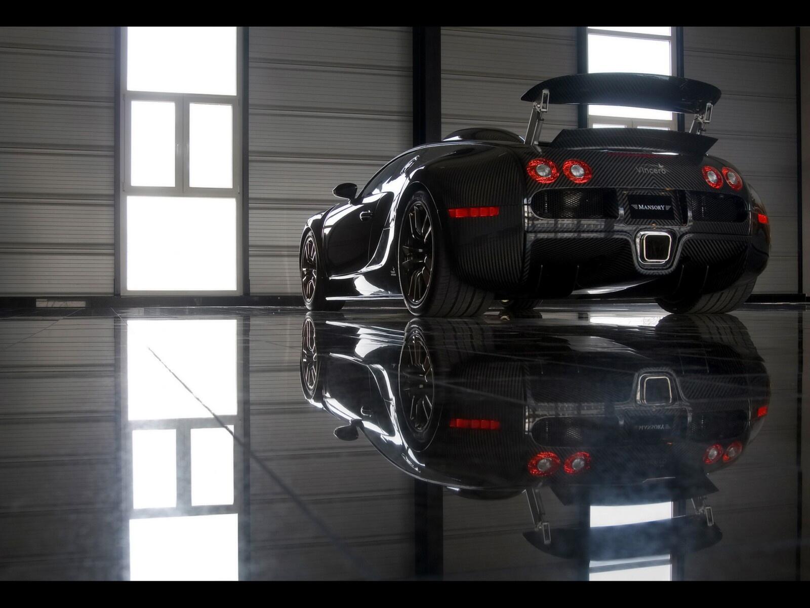Free photo Black Bugatti standing in the hangar, rear view
