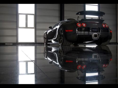 Black Bugatti standing in the hangar, rear view