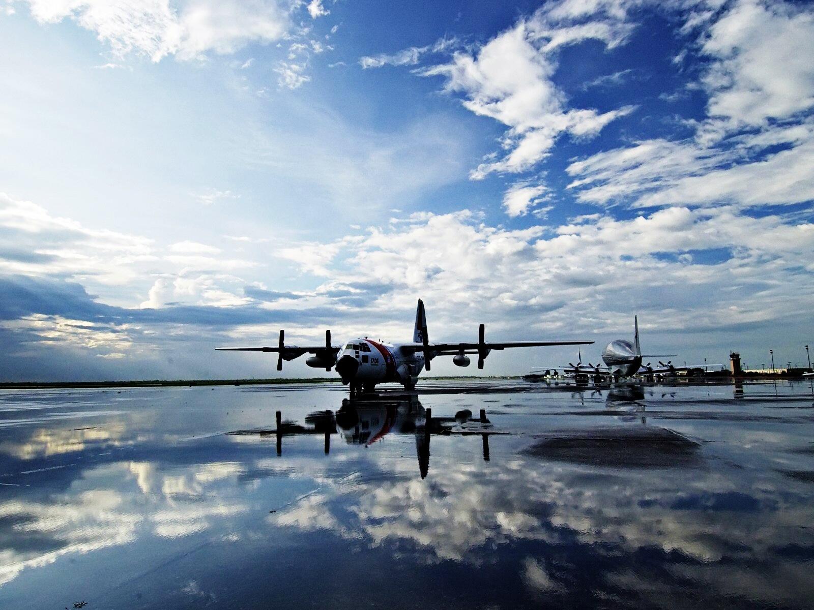 Бесплатное фото Самолеты отражаются на взлетной полосе после дождя