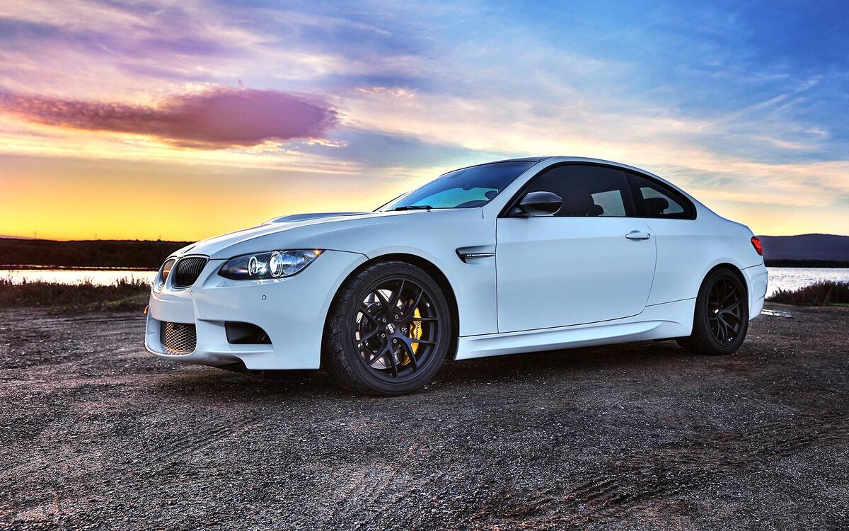 A white bmw coupe at sunset.