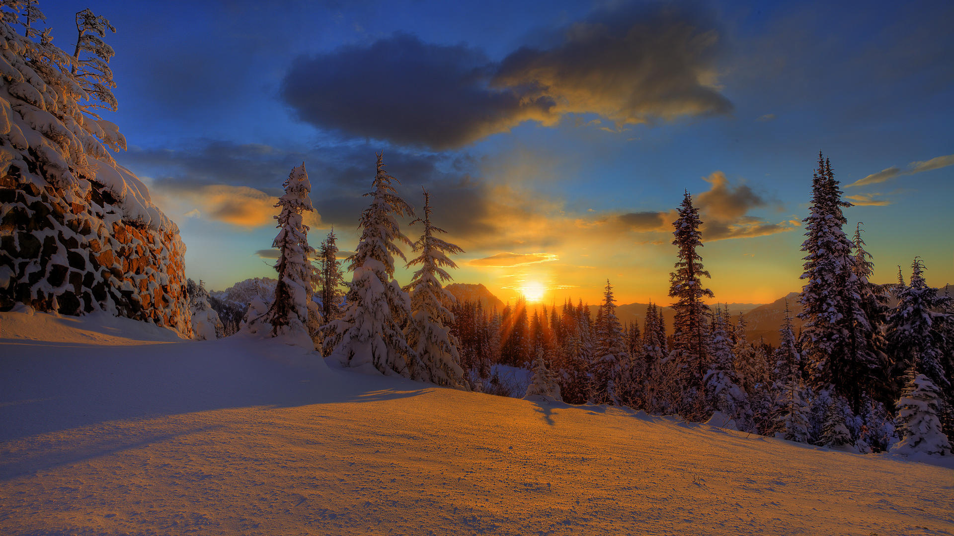 Free photo A field with large snowdrifts at sunset