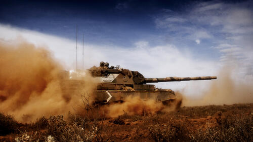 An American tank driving through the sand