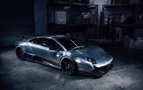 A metallic-colored Lamborghini in a dark garage.