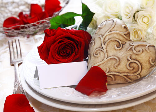 A red rose in a white plate.