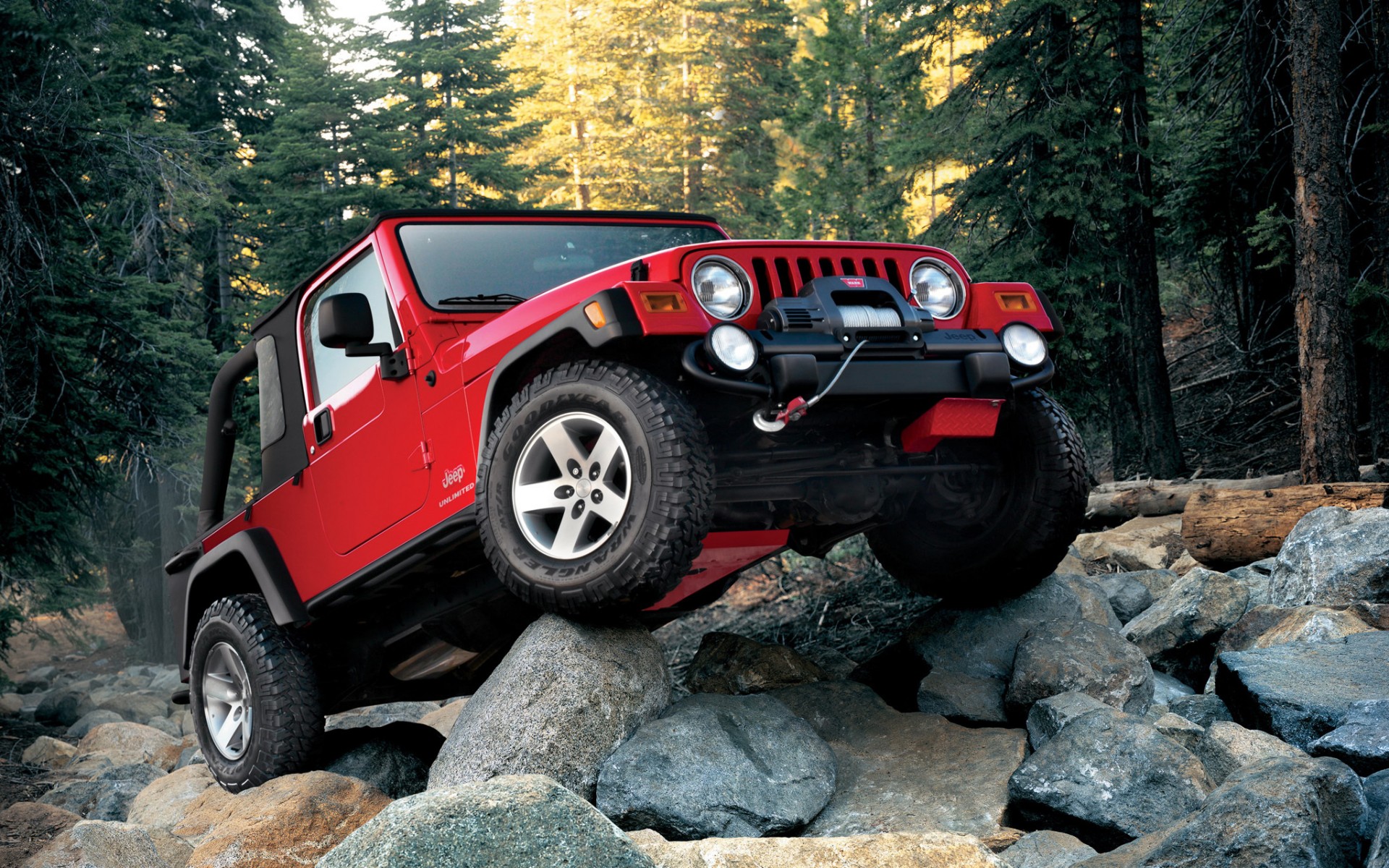 Wallpapers Red Jeep Wrangler stones coniferous forest on the desktop
