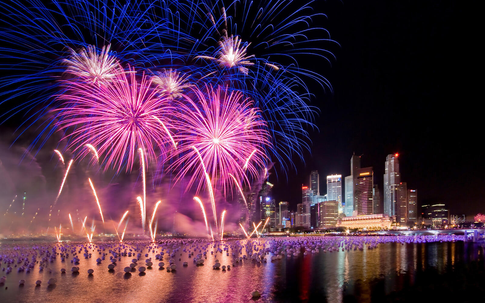 Wallpapers fireworks over the river night skyscrapers on the desktop