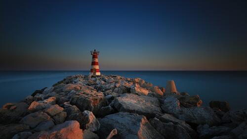 A lighthouse on a rocky stretch of coastline